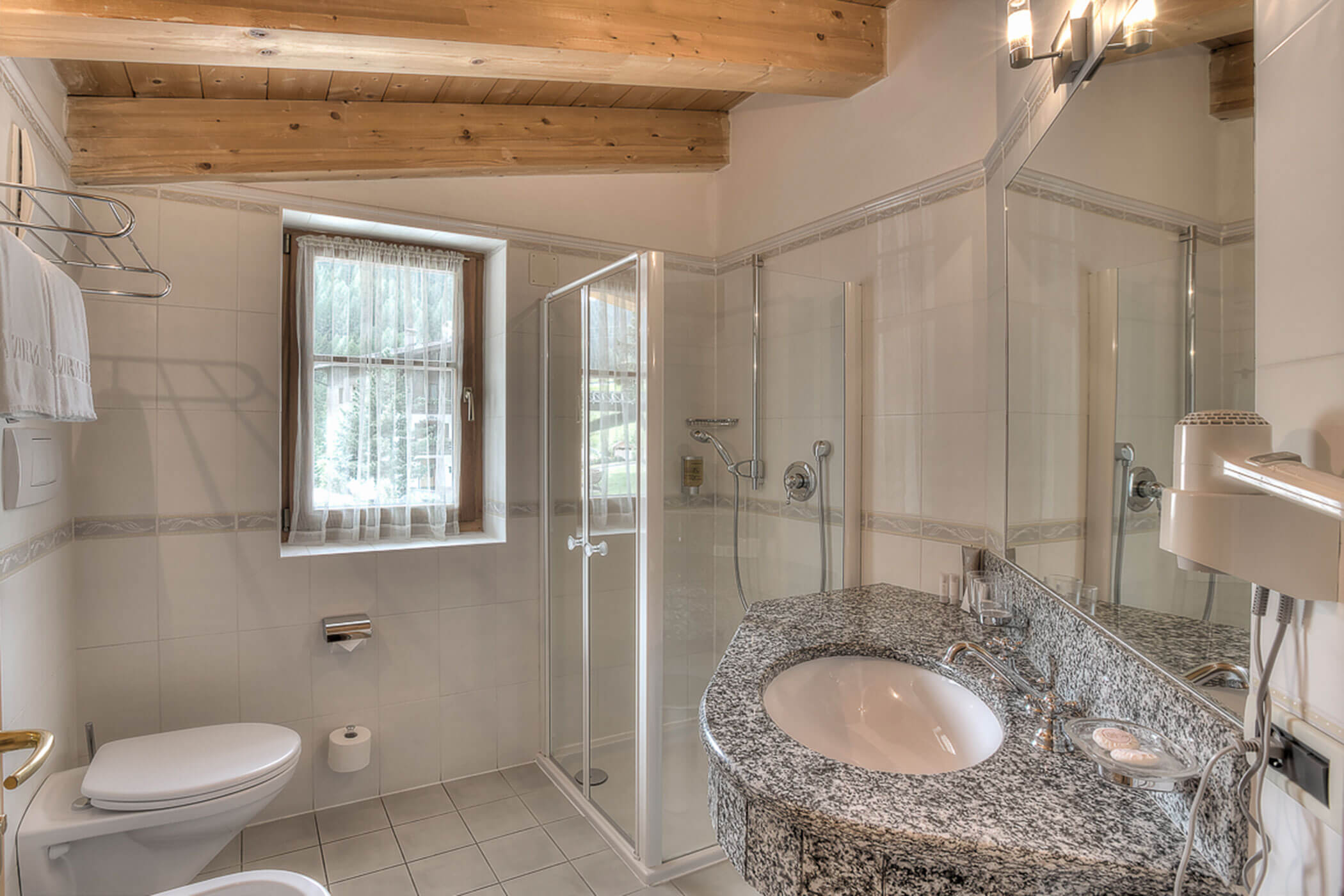 Badezimmer mit Dusche, WC und Waschbecken in der Ferienwohnung Gran Val - Posta Zirm